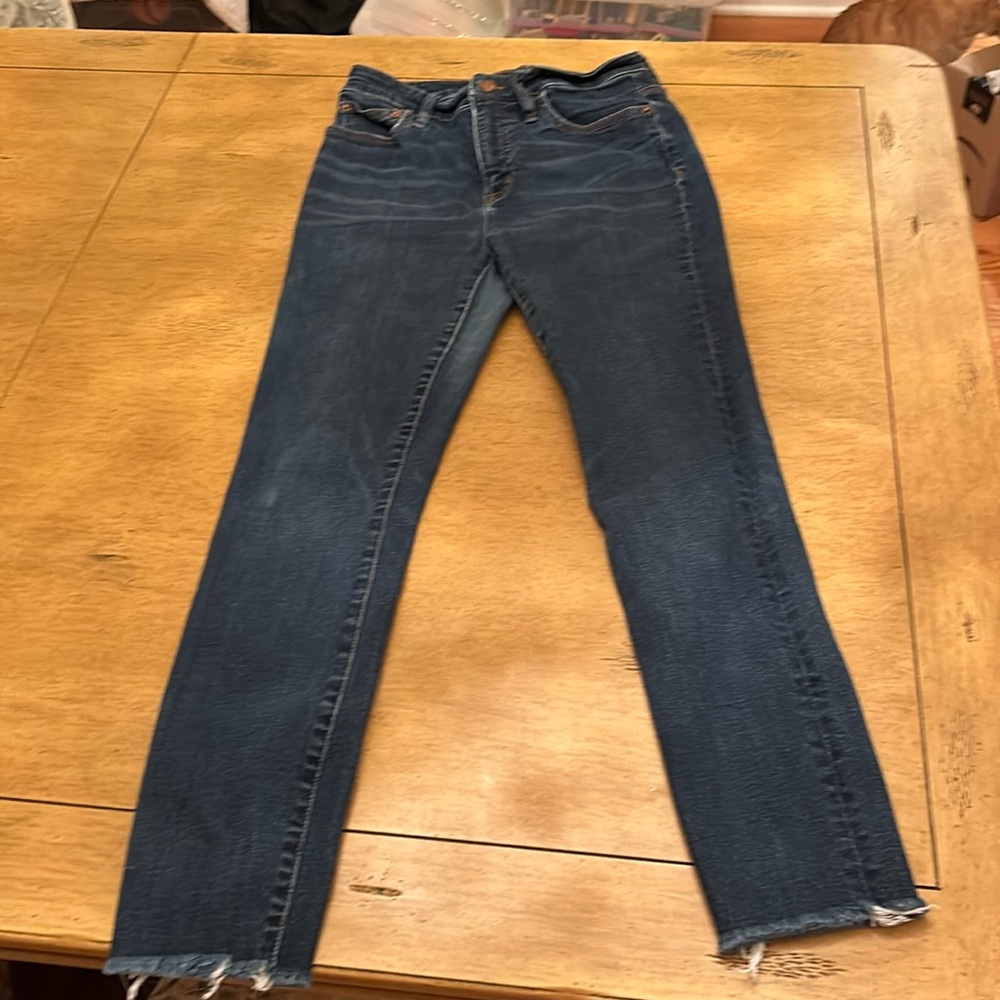 J. Crew medium wash jeans with frayed hem.